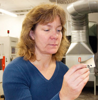 Maria Linder checks some knives after EDM. The entire process is extremely precise and fully computer controlled.